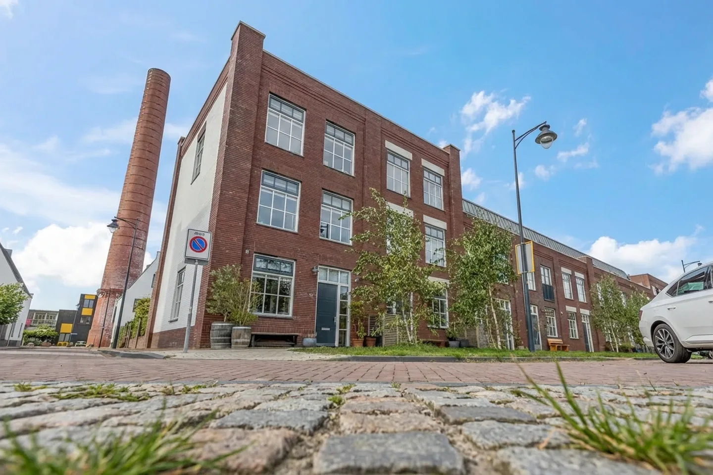 Jorik Otten, Makelaar van Ditters Amersfoort loopt naar de voordeur van de Ditters locatie in Amersfoort voor een bezichtiging, met aktetas en rode fiets bij de gevel.